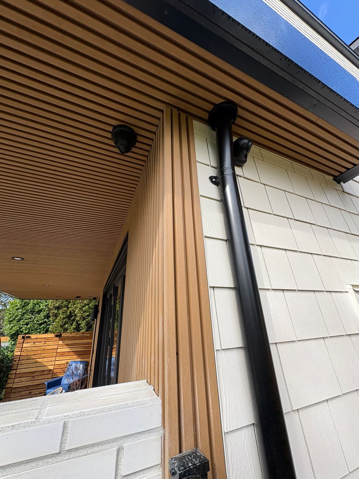 New downspout and cedar siding installation