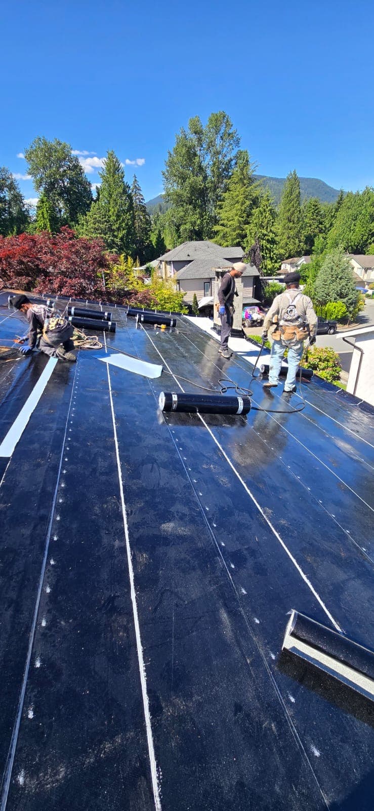 Flat roof membrane installation, crew at work