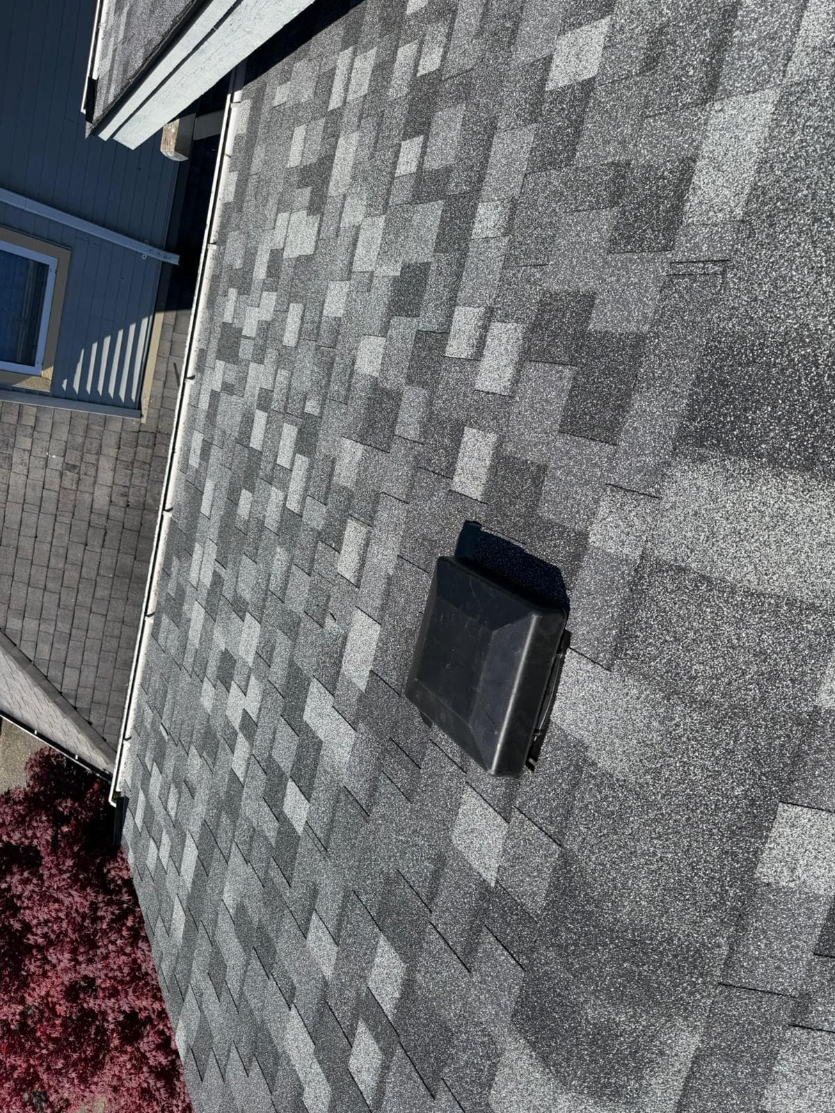 Steep grey shingle slope, completed