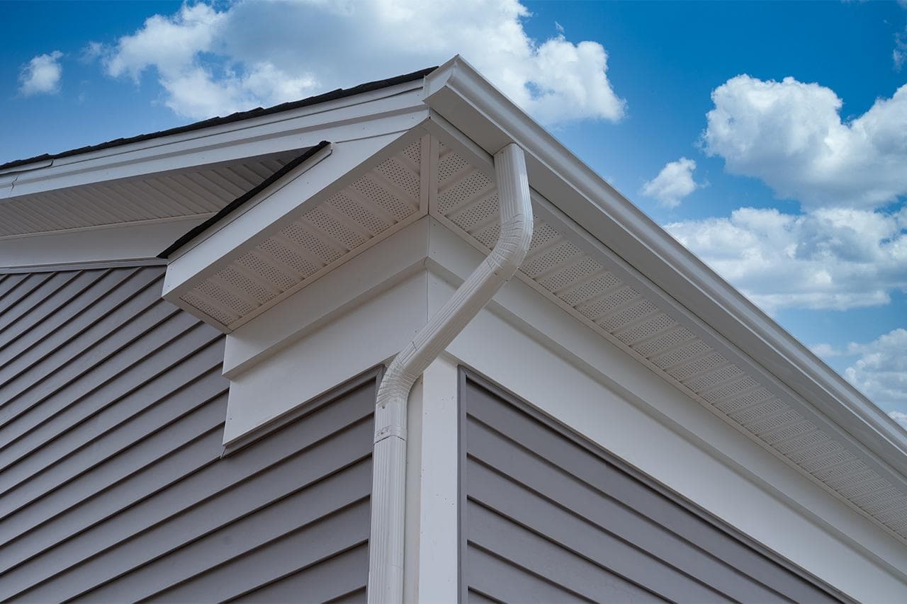 Newly installed seamless gutters and white soffit on a Richmond home